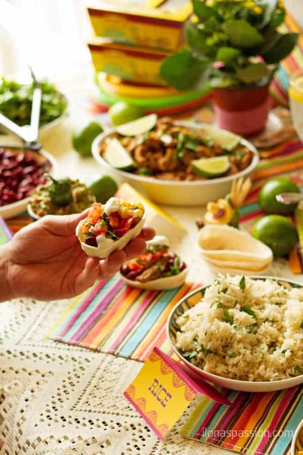 Mexican food recipes menu set up for entertaining with meats and rice.