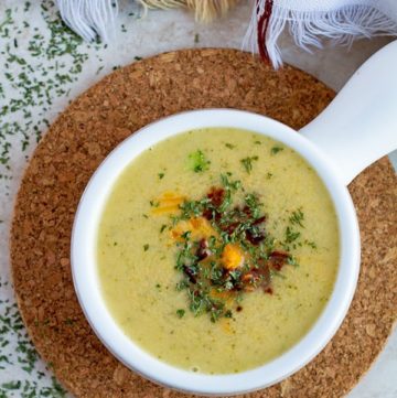 Broccoli cheddar soup topped with parsley.
