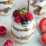 Layers of dairy yogurt with oats, dry and fresh fruits.