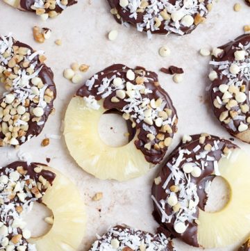 Chocolate covered pineapple with coconut flakes and walnuts.