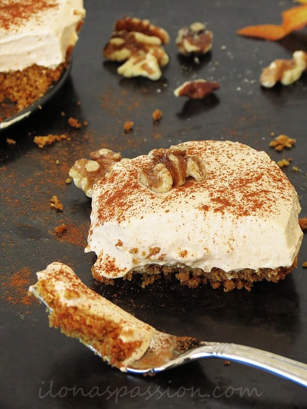 Pumpkin pie dessert topped with walnuts.