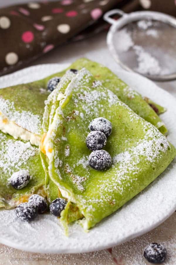 Spinach crepes recipe made with pressed cottage cheese and fresh fruits.