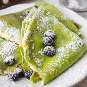 French crepes stuffed with farmer's cheese and mango. Colored green with fresh spinach