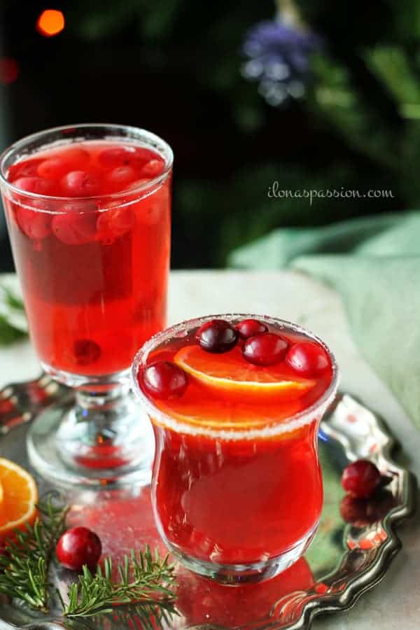 Glasses of cranberries drink served on a silver plate.