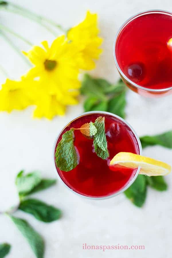 Cherries and lemon drink in a glass.
