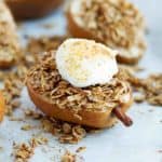 Healthy cinnamon crunch baked pears dessert with coconut sugar and oats. Served with yogurt.