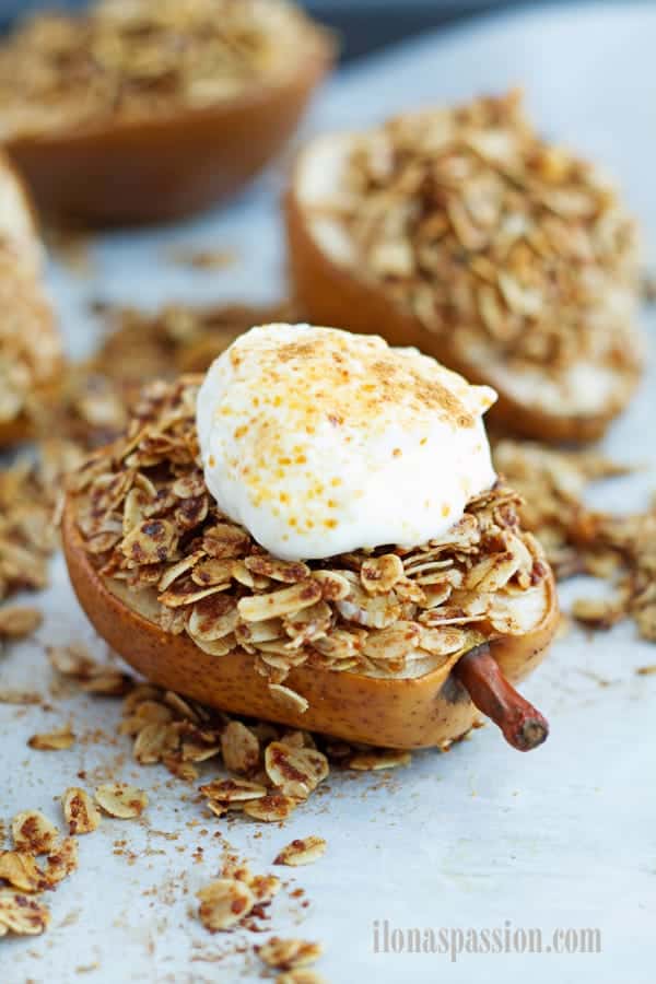 Healthy cinnamon sugar pear cut in half and topped with rolled oats.