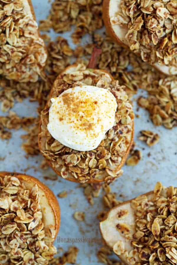 Cooked pears recipe with cinnamon granola topped with yogurt.