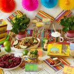 Mexican party table set up with food and drinks.