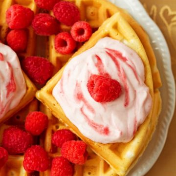 Raspberries and Cream Greek Yogurt Waffles - Sweet, delicious and fluffy raspberries and cream greek yogurt waffles recipe topped with raspberry cream cheese frosting. by ilonaspassion.com I @ilonaspassion