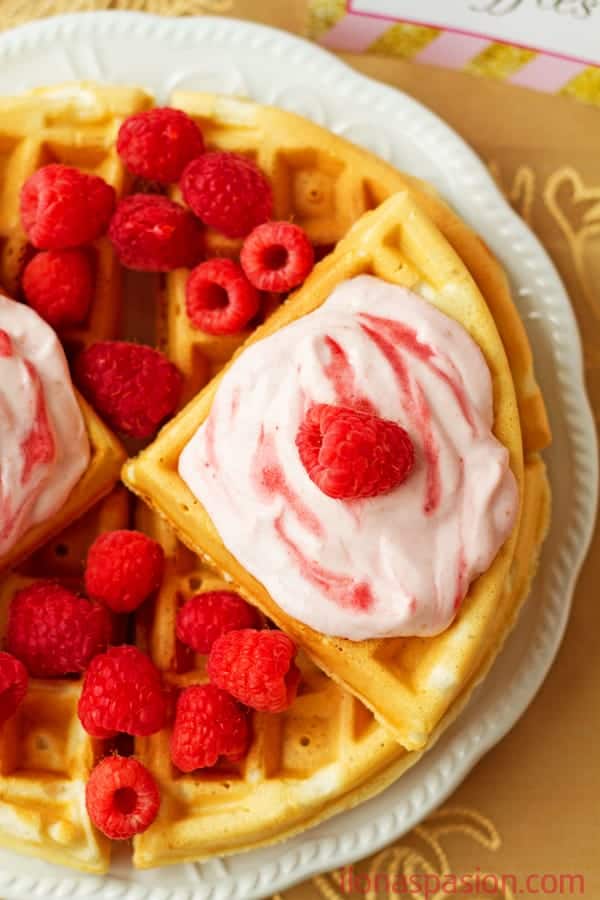 Raspberries and Cream Greek Yogurt Waffles - Sweet, delicious and fluffy raspberries and cream greek yogurt waffles recipe topped with raspberry cream cheese frosting. by ilonaspassion.com I @ilonaspassion