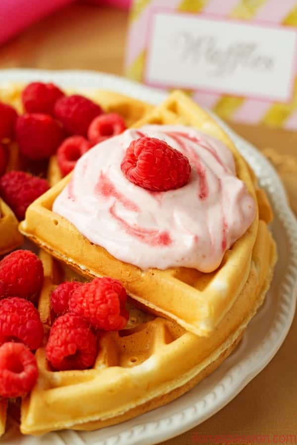 Raspberries and Cream Greek Yogurt Waffles - Sweet, delicious and fluffy raspberries and cream greek yogurt waffles recipe topped with raspberry cream cheese frosting. by ilonaspassion.com I @ilonaspassion