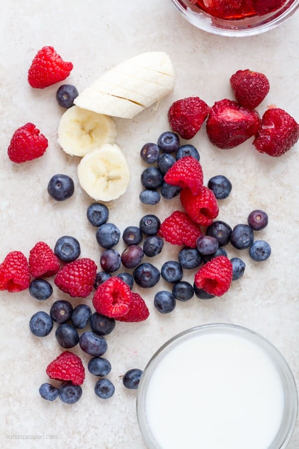 Strawberries, raspberries and blueberries to make triple berry smoothie.