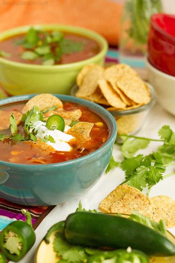 Taco chicken soup party with toppings made in slow cooker. 