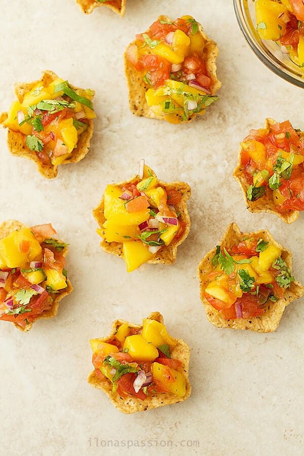 Overhead photo of sweet mango sals made with only 4 ingredients. Appetizer mini cups for party.