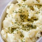 Creamy mashed potatoes in a bowl topped with butter and chive by ilonaspassion.com I @ilonaspassion
