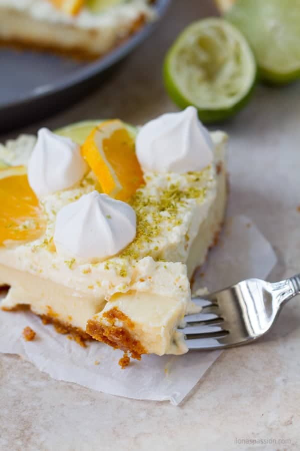 Fork dipped into graham crust key lime pie.