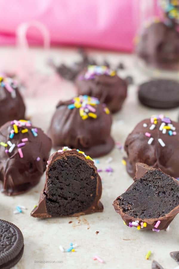 An inside of gooey chocolate cheesecake truffles with sprinkles.