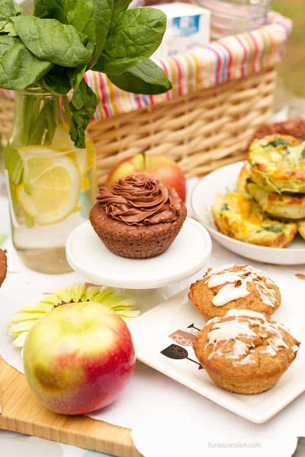 Brownies, apples, gluten free muffins, breakfast muffins on a table in the park.