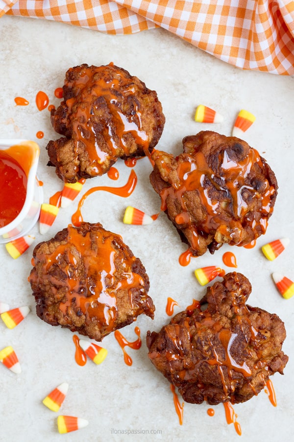 4 apple fritters with candy syrup.