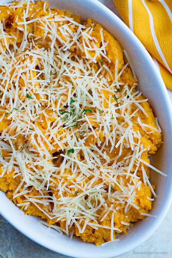 Mashed sweet potatoes with shredded parmesan on top.