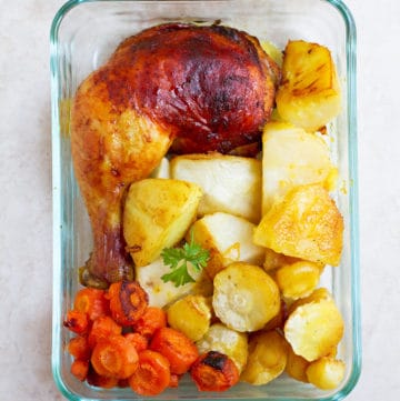 Chicken leg with potatoes and carrots.