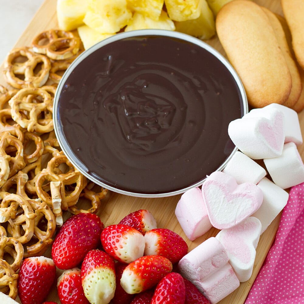 Chocolate fondue with fruits and pretzels, marshmallows.