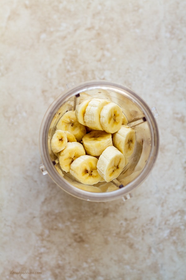 Sliced banana in a blender cup.