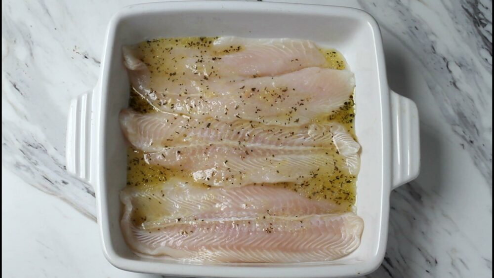 Raw fish in marinate in a bowl.