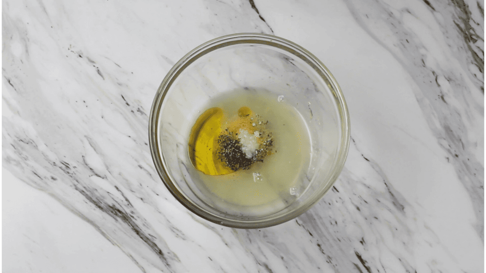 Oil, lemon juice and spices in a small bowl.