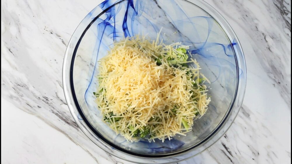 Chopped broccoli and parmesan cheese in a bowl.