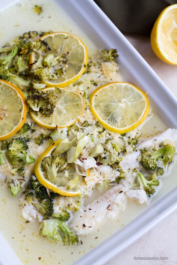 White fish with broccoli, buttery, cheesy sauce.