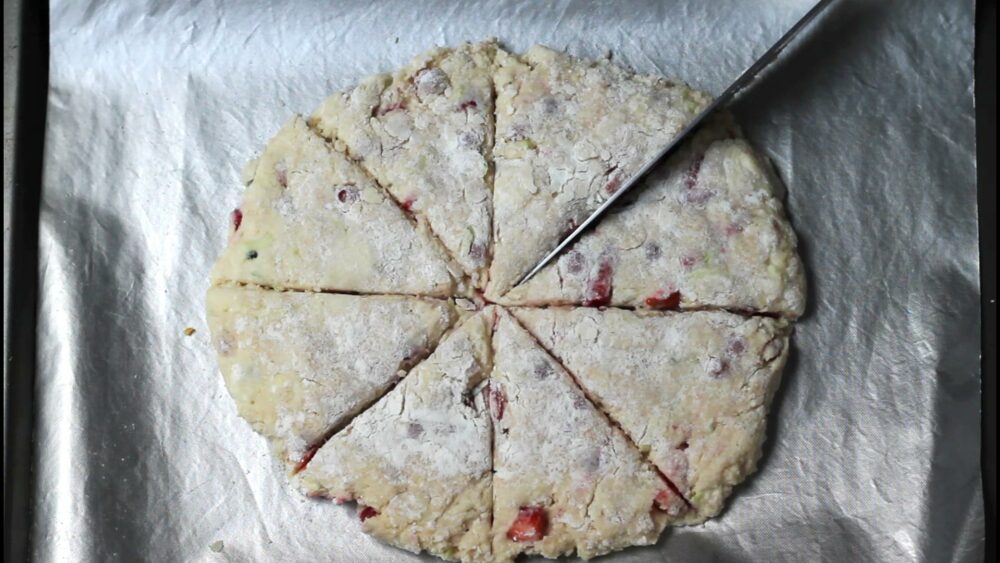 Cutting unbaked scones into 8 triangles before baking.