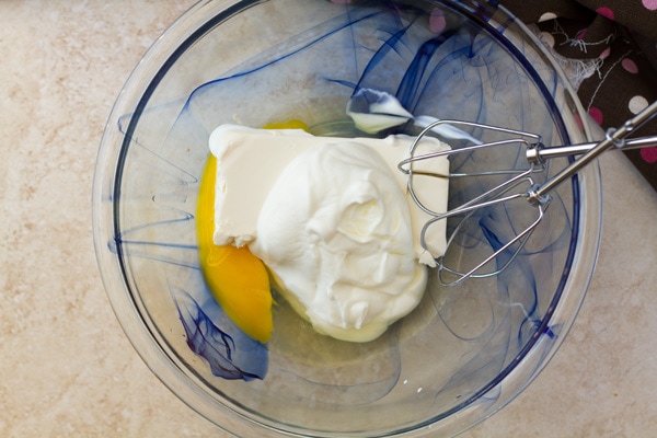Eggs, cream cheese and greek yogurt in a bowl.