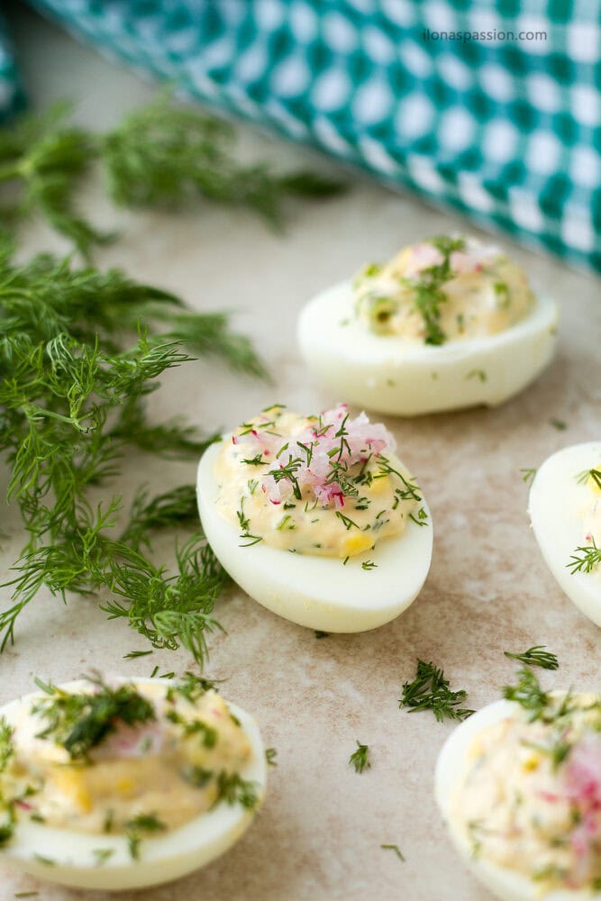 Stuffed deviled egg with mayo and fresh herb.