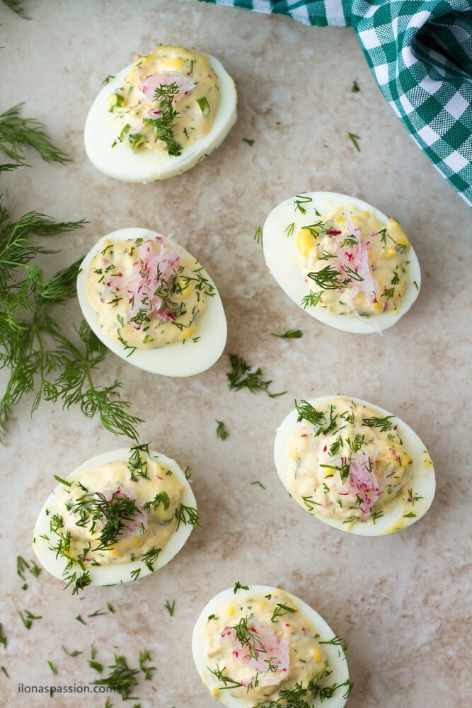 Stuffed Easter egg with fresh dill and radish.