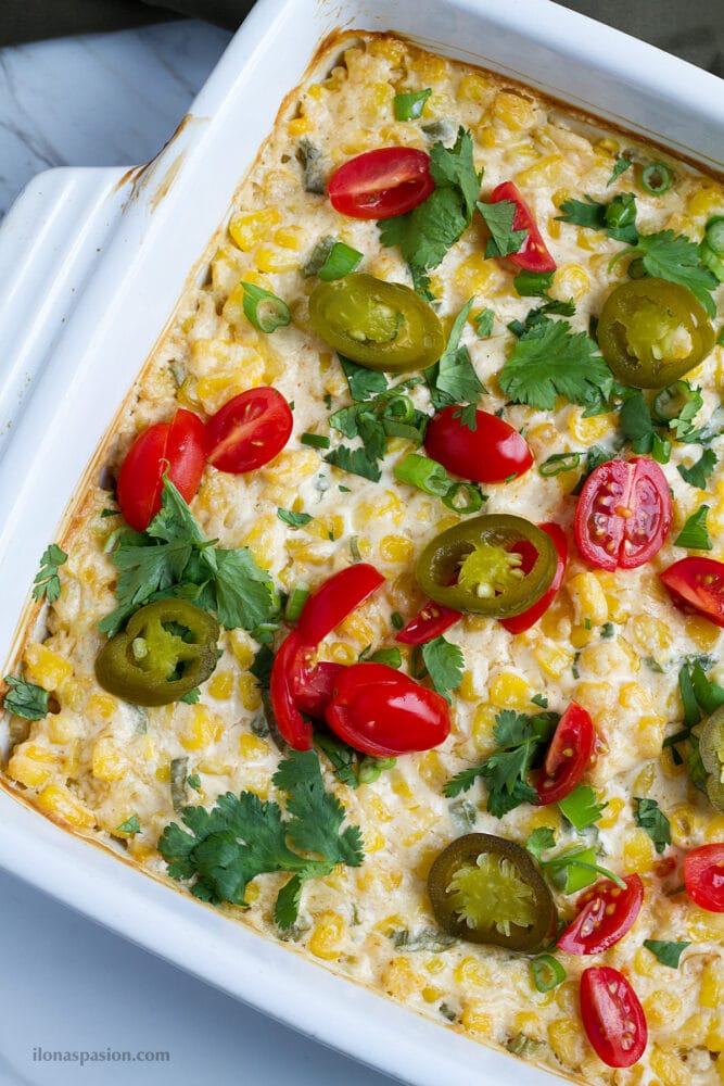 Cream cheese corn dip with tomatoes and jalapeno.